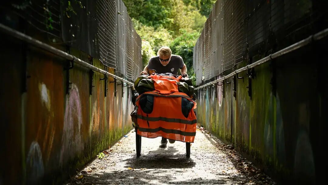 DOVER, ENGLAND - OCTOBER 09: Global adventurer Karl Bushby tackles a steep incline as he begins the route towards the North, on October 09, 2026 in Dover, England. Karl Bushby first set off from Chile in November 1998 with the mission of traversing the world on foot without the use of transport, and only returning home to the UK once the journey was complete. After trekking nearly 28 years and 30,000 miles (48,000km) through 29 countries, the former British paratrooper completed a multi-day swim across the English Channel on October 5, touching back on UK soil for the first time in Dover. The final leg of the remarkable journey he refers to as the Goliath Expedition will see Bushby walk more than 250 miles (400km) to his mother's home in Hull, northeast England. (Photo by Leon Neal/Getty Images)